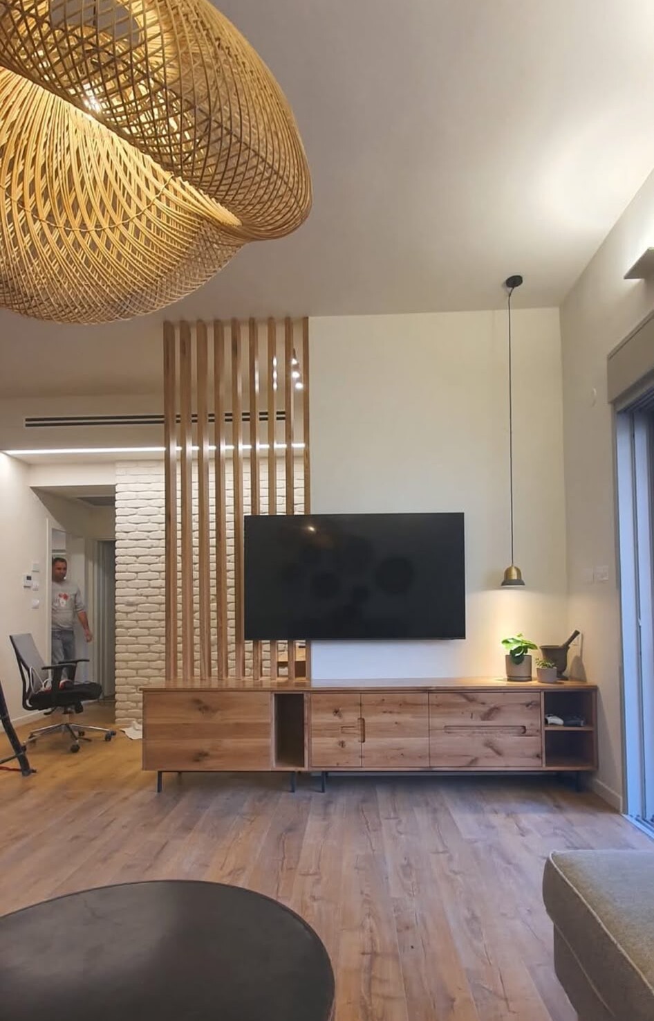 A designed living room with a rattan pendant lamp