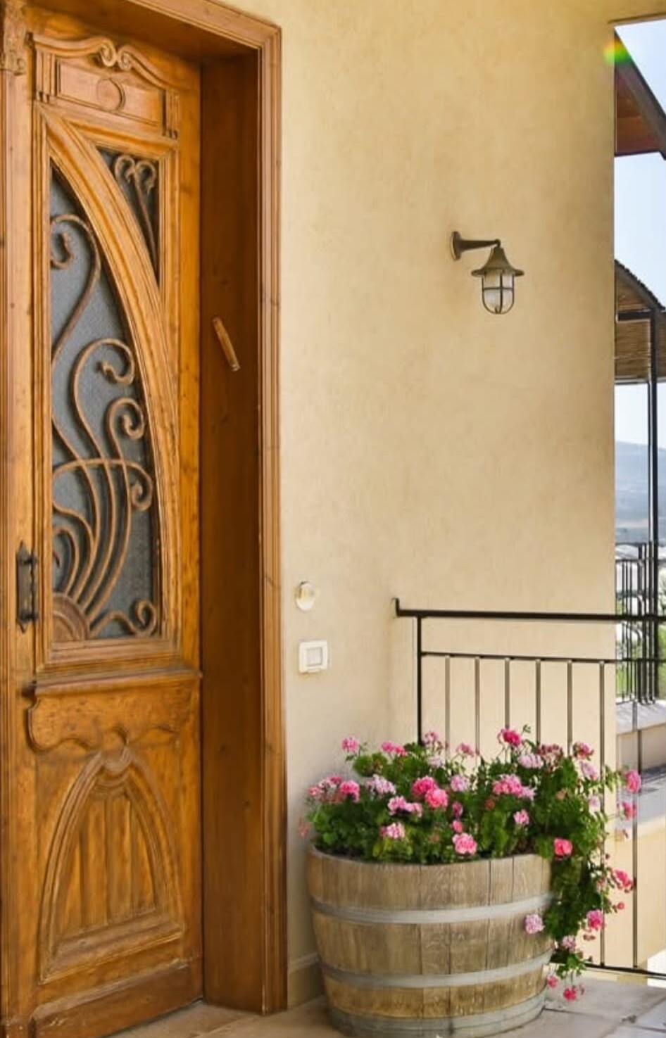 An antique wall sconce installed at a home entrance
