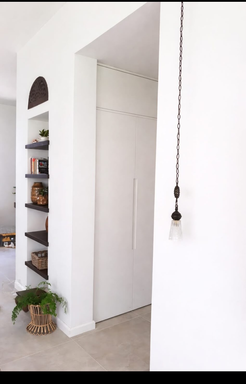 A pendant lamp with an antique medallion in a hallway